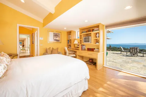 a spacious bedroom with a bed and a large window