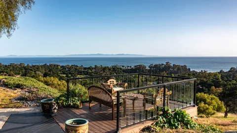 a view of a balcony with an outdoor seating
