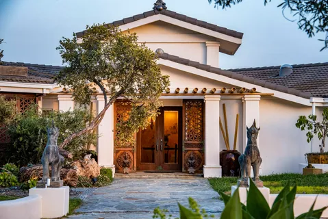 front view of a house with potted plants