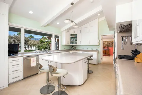 a kitchen with stainless steel appliances granite countertop a sink a stove and a refrigerator