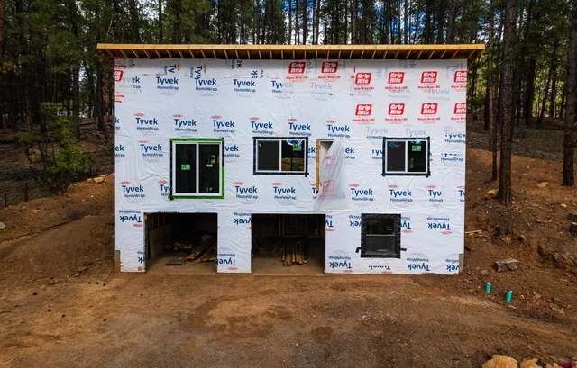 a green field with some trees in the background
