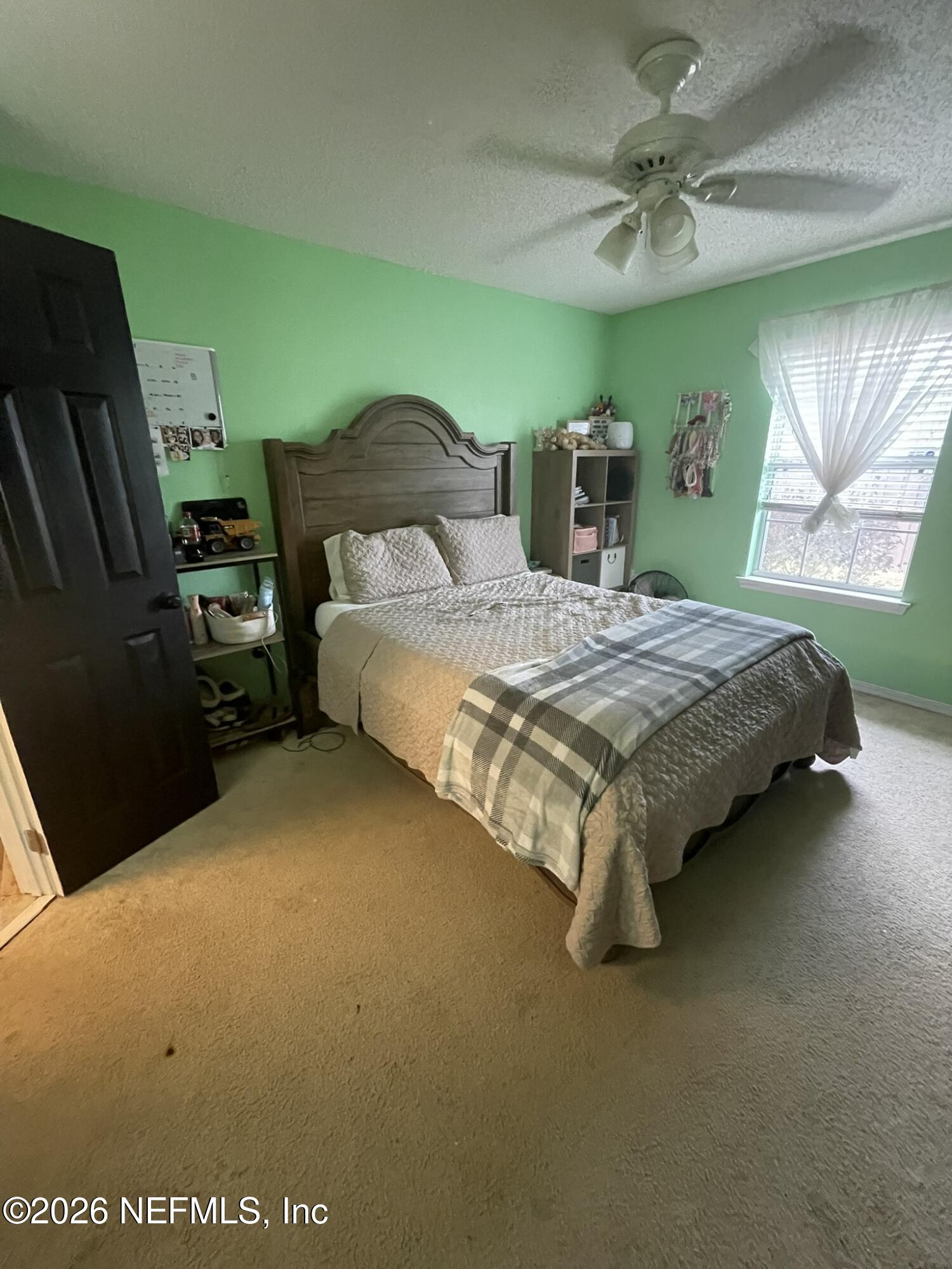 2946 Longleaf Ranch Circle Middleburg, FL 32068 - Photo 11 of 18 a bedroom with a bed and a window