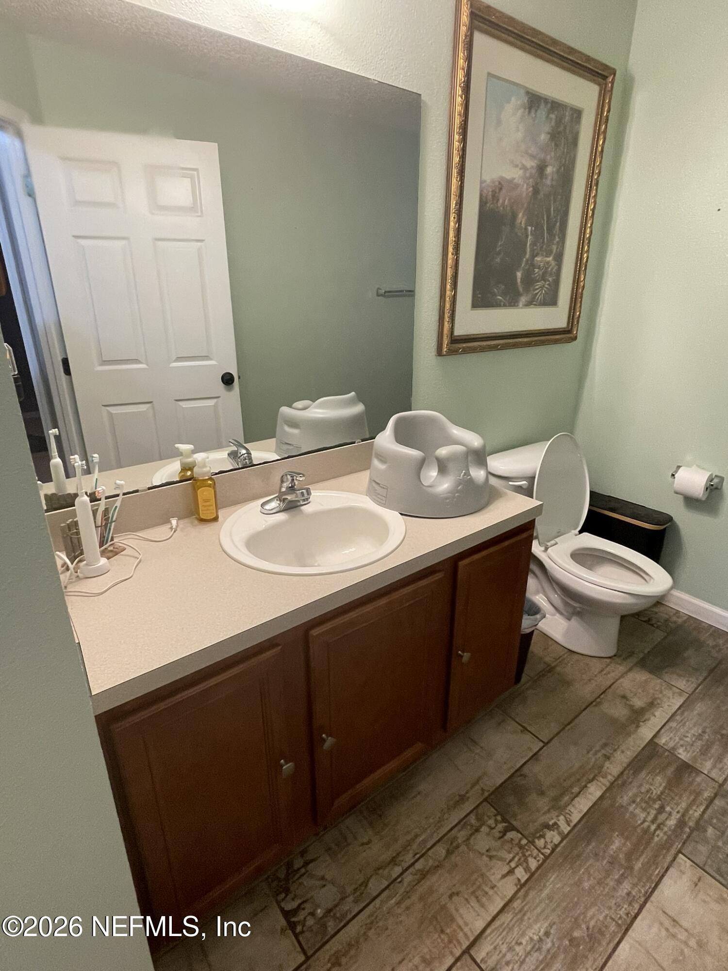 2946 Longleaf Ranch Circle Middleburg, FL 32068 - Photo 14 of 18 a bathroom with a sink toilet and mirror