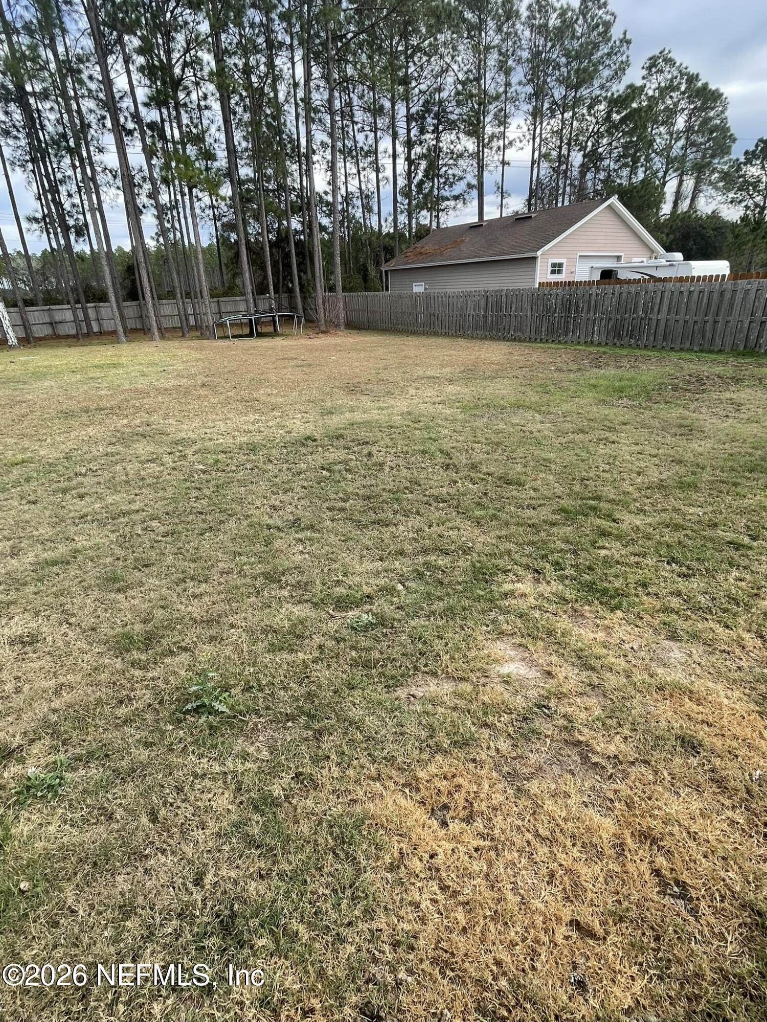2946 Longleaf Ranch Circle Middleburg, FL 32068 - Photo 17 of 18 a house with yard and trees in the background