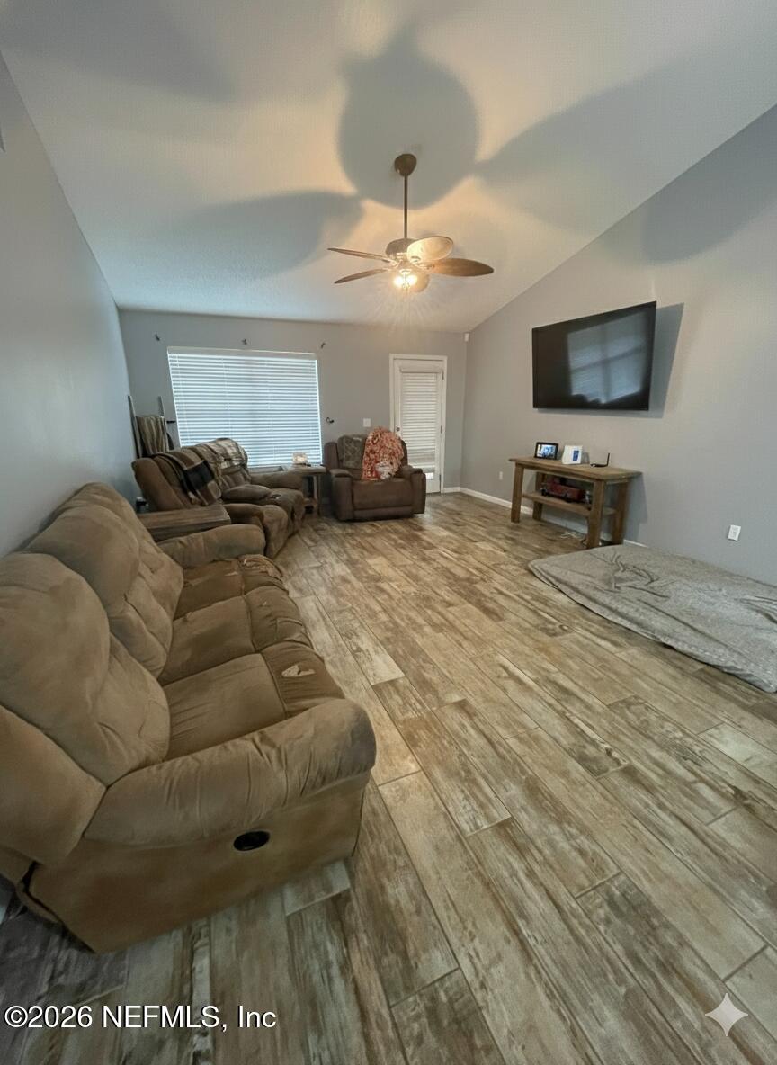 2946 Longleaf Ranch Circle Middleburg, FL 32068 - Photo 2 of 18 a living room with furniture and a flat screen tv
