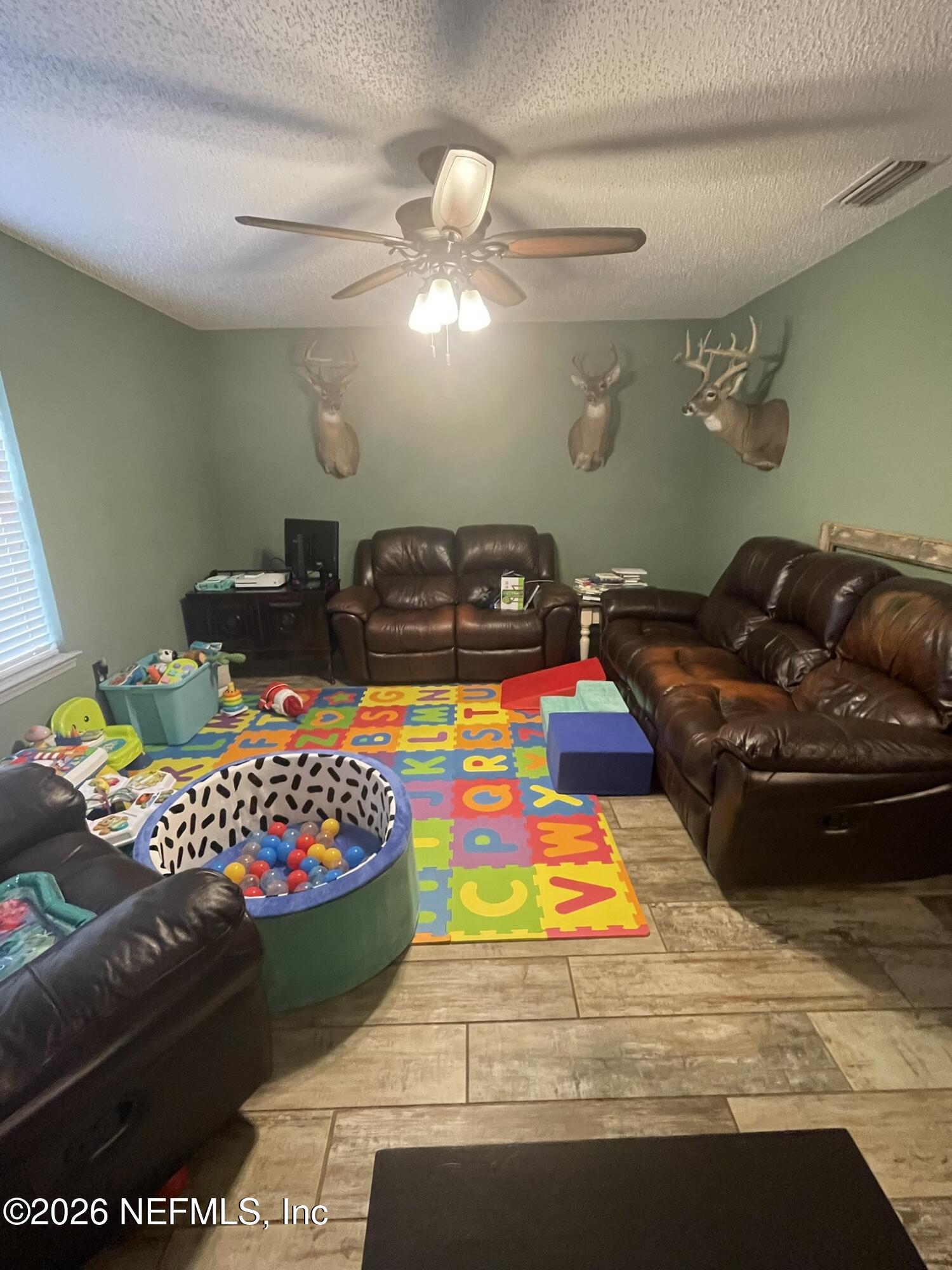 2946 Longleaf Ranch Circle Middleburg, FL 32068 - Photo 4 of 18 a bed sitting in a bedroom next to a window