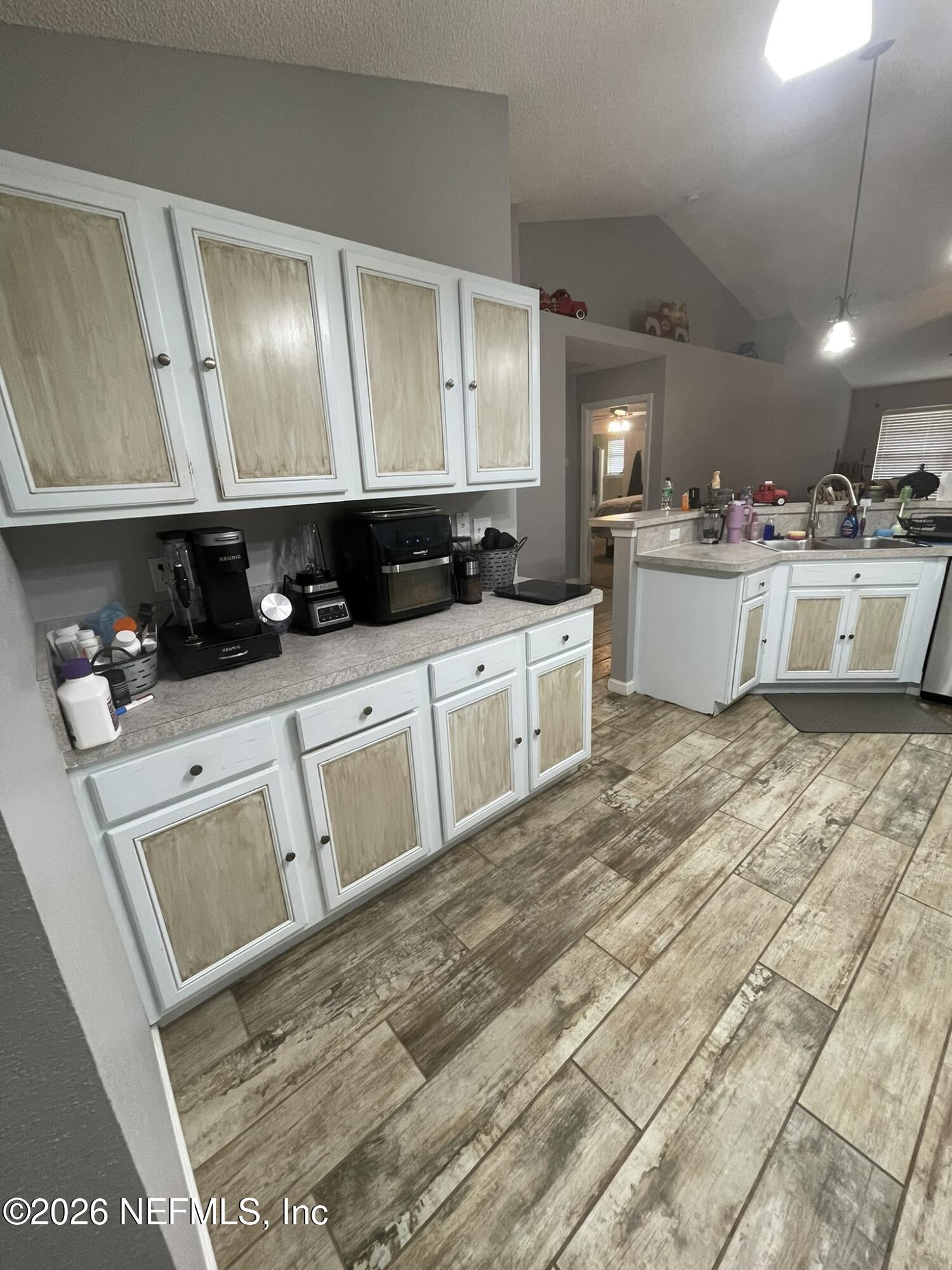 2946 Longleaf Ranch Circle Middleburg, FL 32068 - Photo 7 of 18 a kitchen with stainless steel appliances granite countertop a sink a stove top oven and cabinets