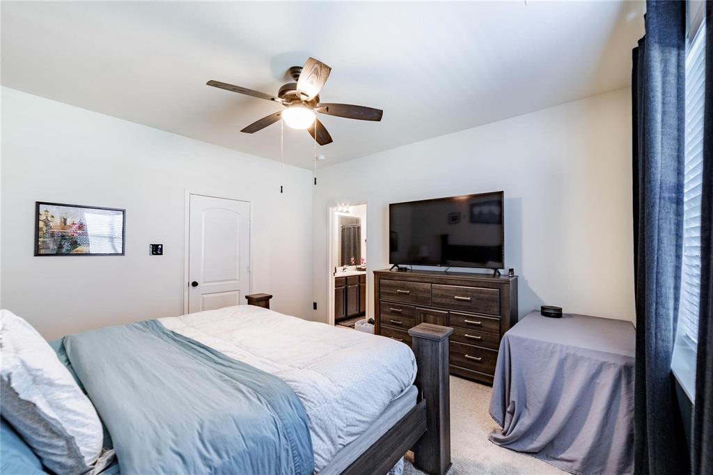 3021 Earl Road Anna, TX 75409 - Photo 11 of 20 a bedroom with a bed and a flat screen tv