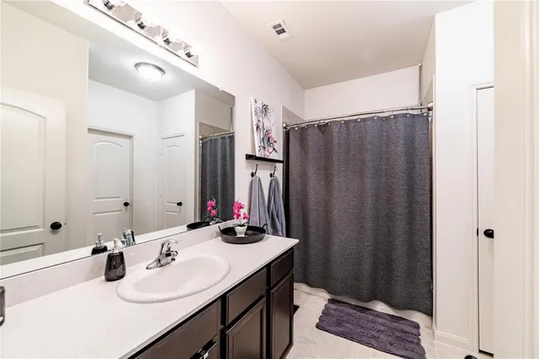 a bathroom with double vanity sink and a mirror