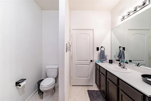 a bathroom with a sink a toilet and a mirror