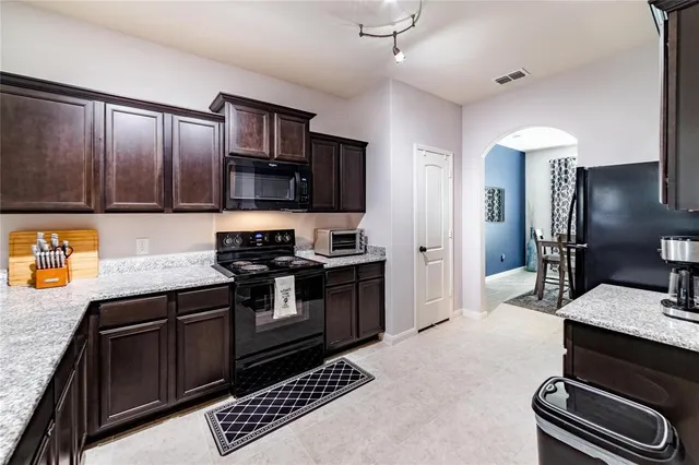 a kitchen with a sink stove and refrigerator