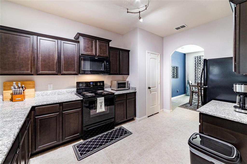 3021 Earl Road Anna, TX 75409 - Photo 8 of 20 a kitchen with a sink stove and refrigerator