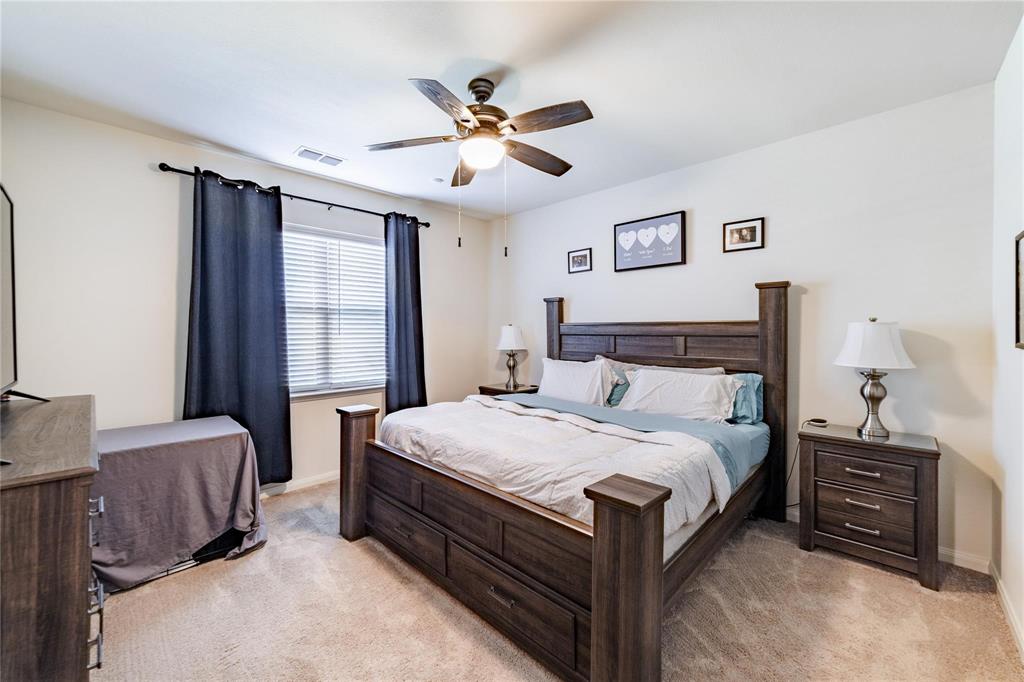 3021 Earl Road Anna, TX 75409 - Photo 9 of 20 a bedroom with a bed and a chandelier