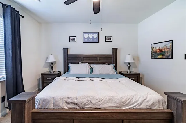 a bedroom with a bed and painting on the wall