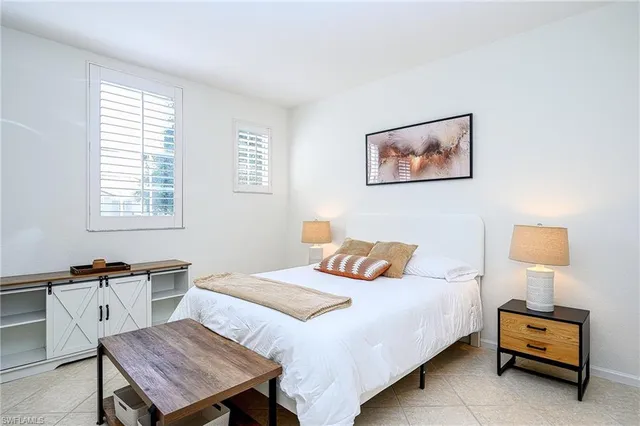 a bedroom with a bed and a night stand