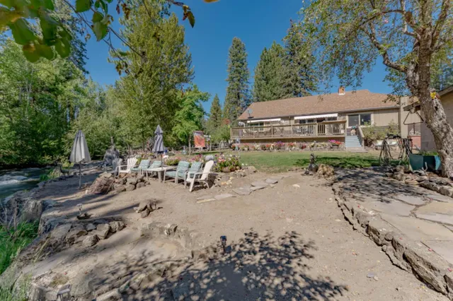 a bathroom with a sink a mirror and potted plants