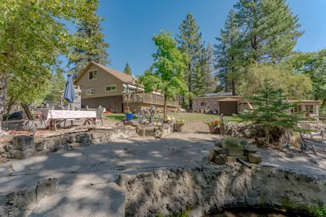 a view of a chairs and table in the backyard