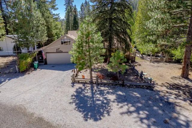 a view of a lush green hillside and houses