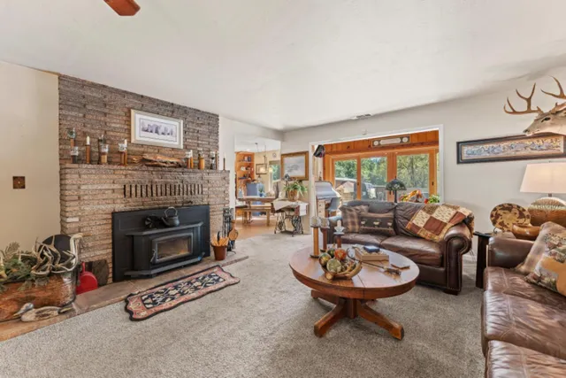 a living room with furniture a rug and a large window