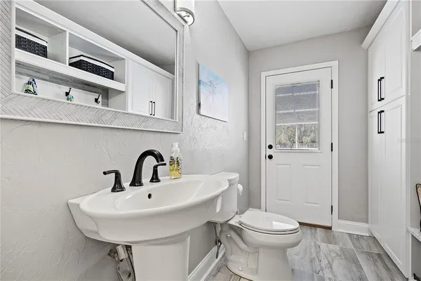a view of a porch with wooden floor and fence