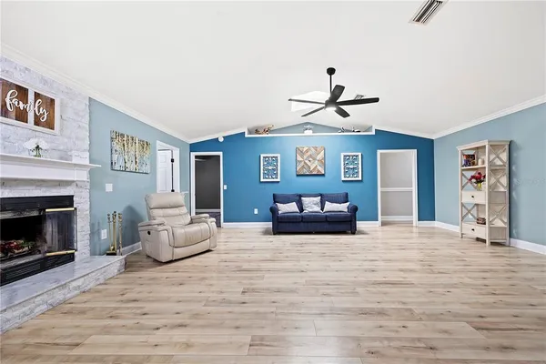 a dining room with furniture a chandelier and wooden floor