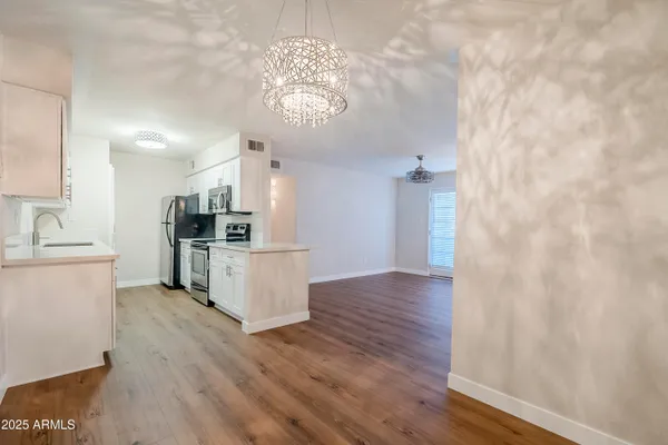 a kitchen with stainless steel appliances a refrigerator and a stove top oven