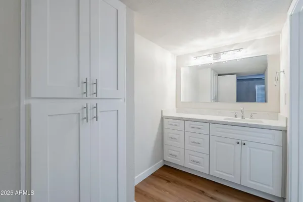 a spacious bathroom with a mirror and a sink