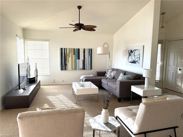 a living room with furniture and a lamp