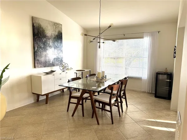a dining room with furniture and window