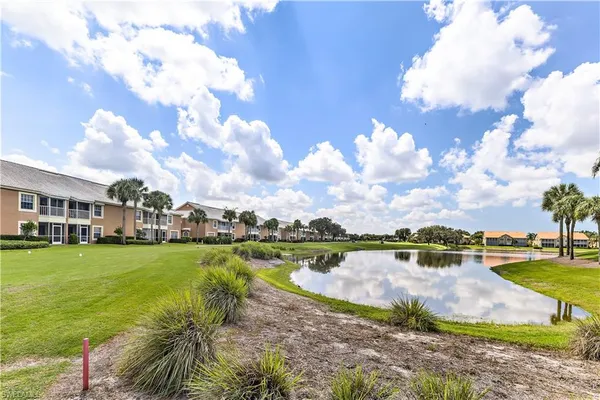 a view of a lake with houses in the back