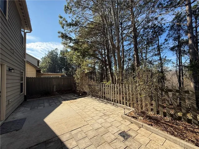a view of backyard with wooden fence