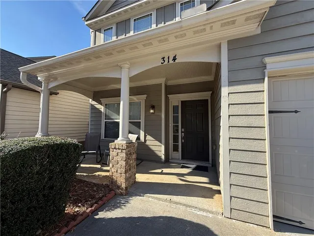 a front view of a house with a glass windows