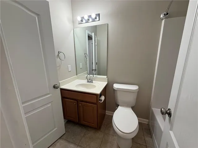 a bathroom with a sink a toilet and mirror