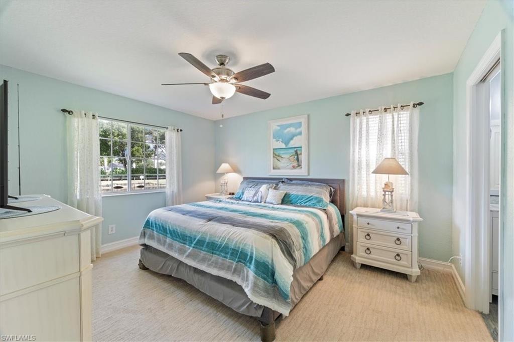 1715 Reuven Circle, Unit 2103 Naples, FL 34112 - Photo 14 of 38 Bedroom with light carpet and a ceiling fan