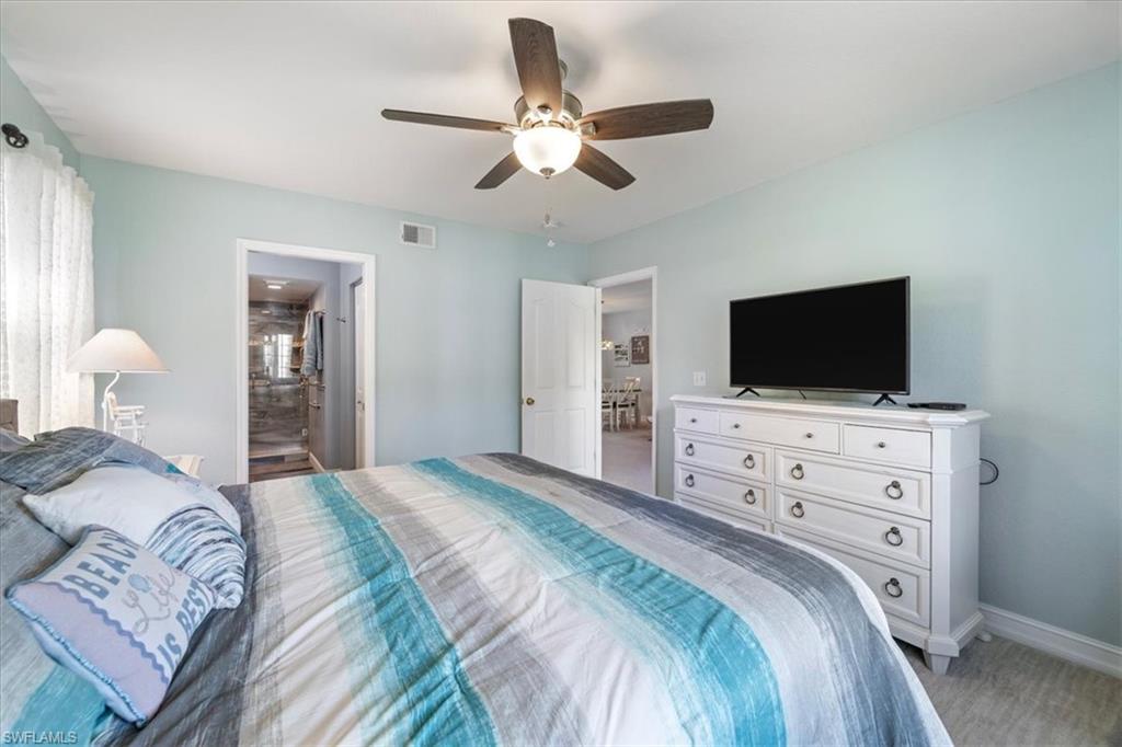 1715 Reuven Circle, Unit 2103 Naples, FL 34112 - Photo 17 of 38 a bedroom with a bed tv on desk and a window