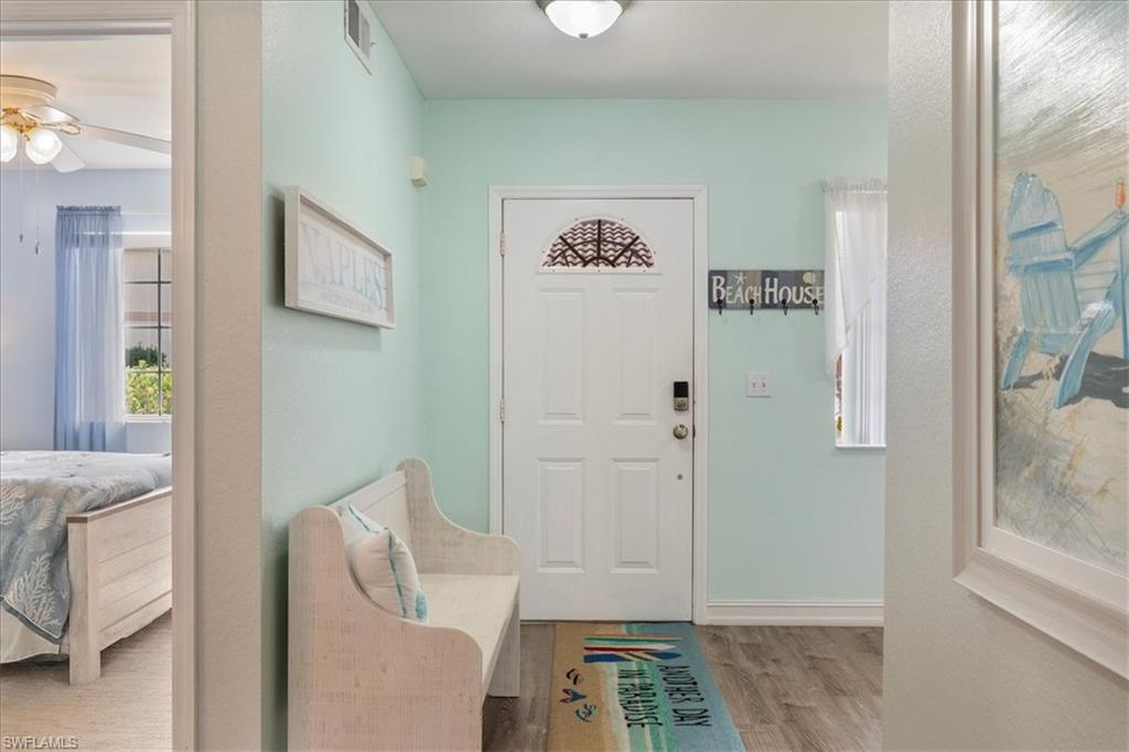 1715 Reuven Circle, Unit 2103 Naples, FL 34112 - Photo 24 of 38 Entrance foyer with wood finished floors and ceiling fan