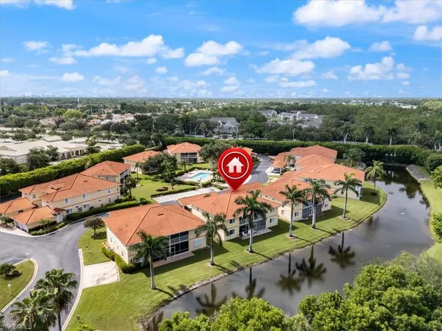an aerial view of a house with a swimming pool yard and mountain view in back