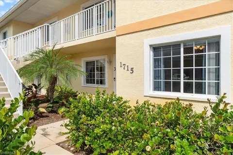 a front view of a house with a flower garden