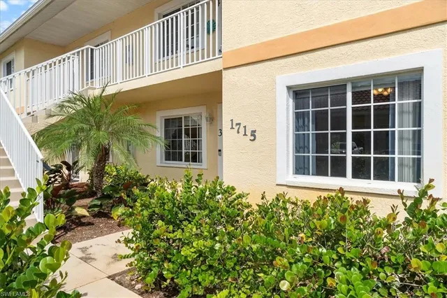 a front view of a house with a flower garden