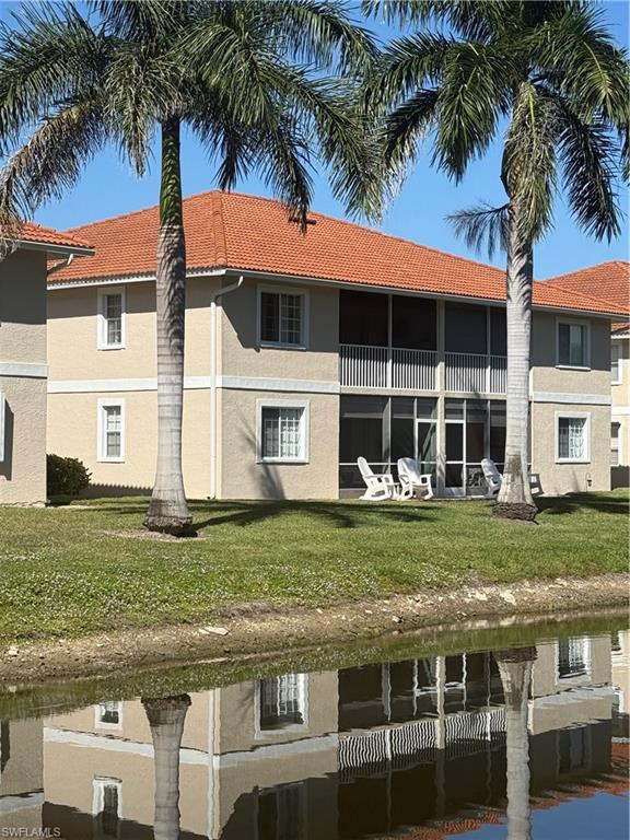 1715 Reuven Circle, Unit 2103 Naples, FL 34112 - Photo 30 of 40 a view of a house with a yard and palm trees