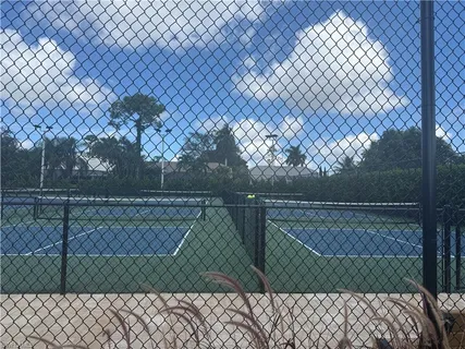 a green field with trees in the background