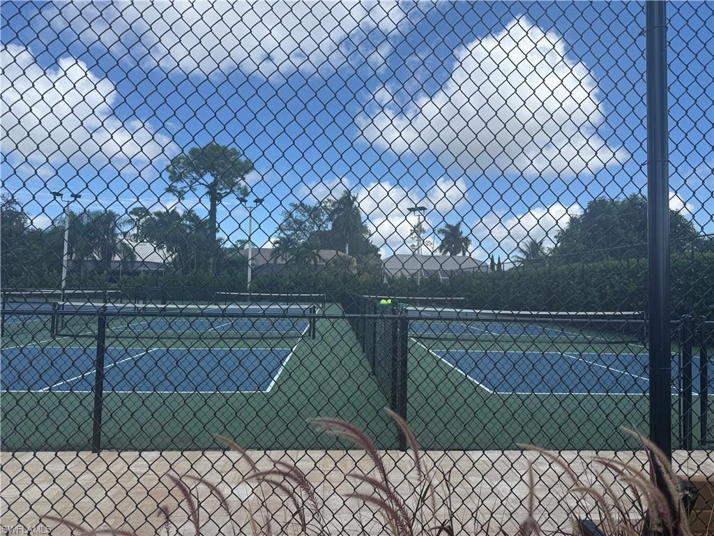 1715 Reuven Circle, Unit 2103 Naples, FL 34112 - Photo 32 of 38 a green field with trees in the background