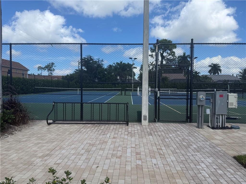 1715 Reuven Circle, Unit 2103 Naples, FL 34112 - Photo 32 of 38 View of tennis court with a gate