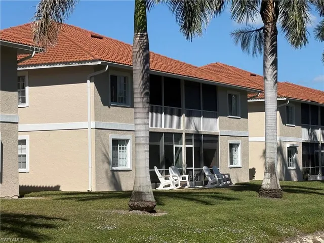 a view of a house with a yard and plants