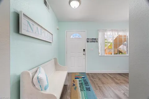 a view of a hallway to a livingroom with furniture