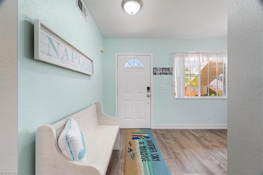 1715 Reuven Circle, Unit 2103 Naples, FL 34112 - Photo 5 of 38 a view of a hallway to a livingroom with furniture