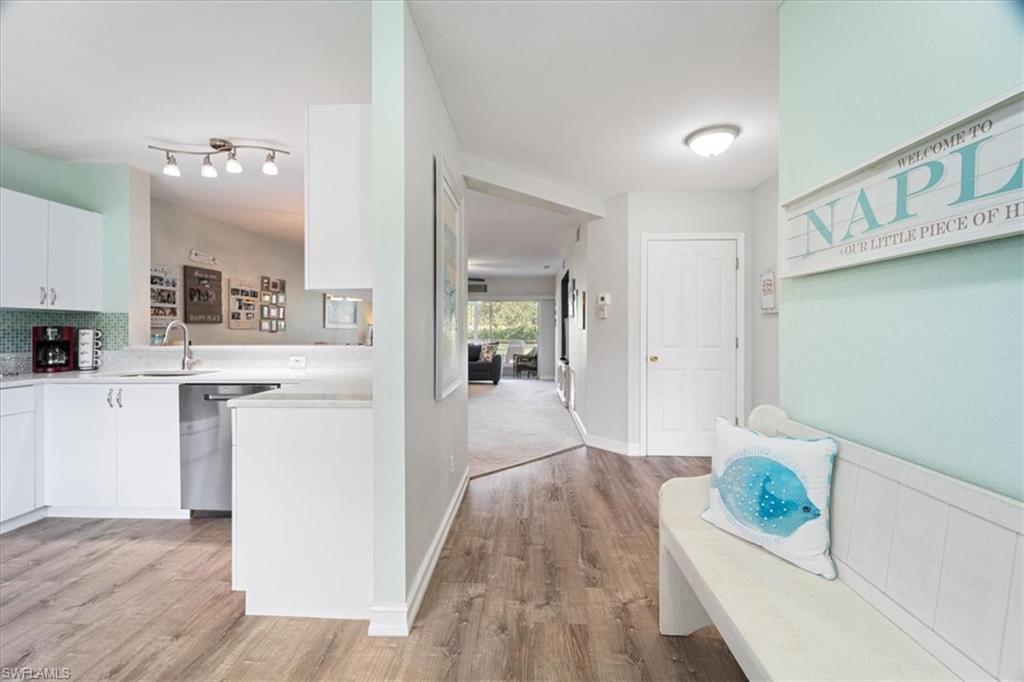 1715 Reuven Circle, Unit 2103 Naples, FL 34112 - Photo 6 of 38 a living room with furniture and a wooden floor