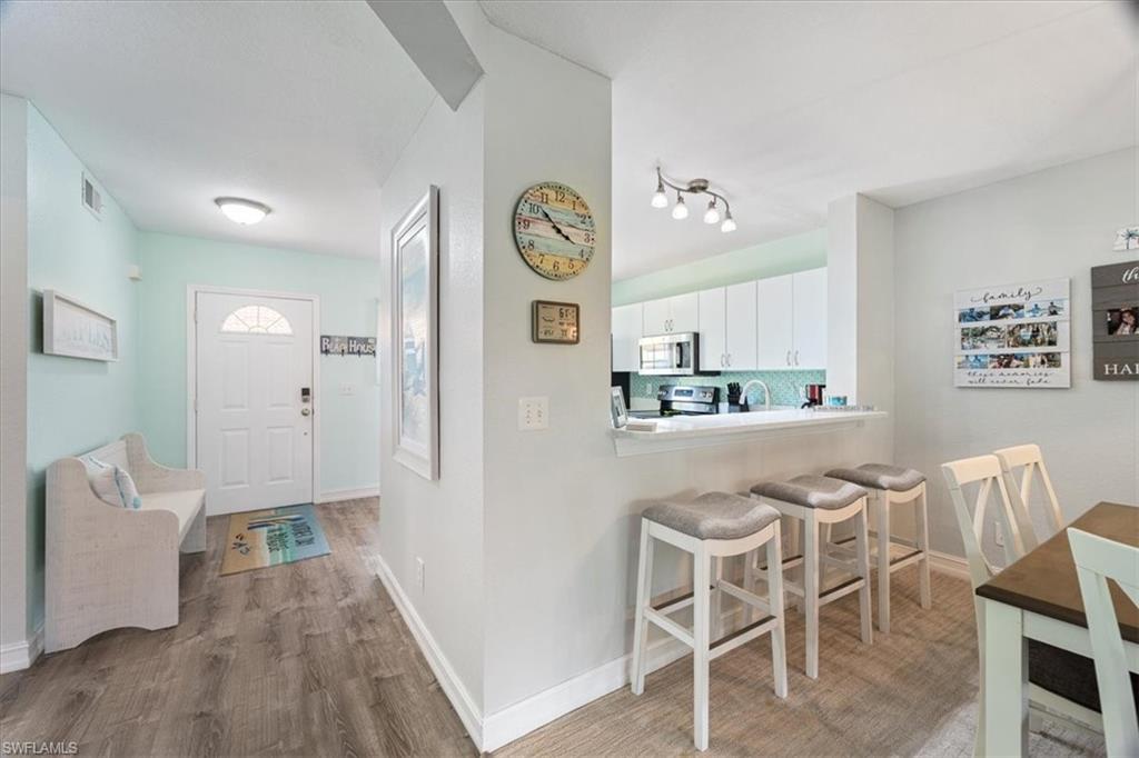 1715 Reuven Circle, Unit 2103 Naples, FL 34112 - Photo 9 of 38 a dining room with furniture and window