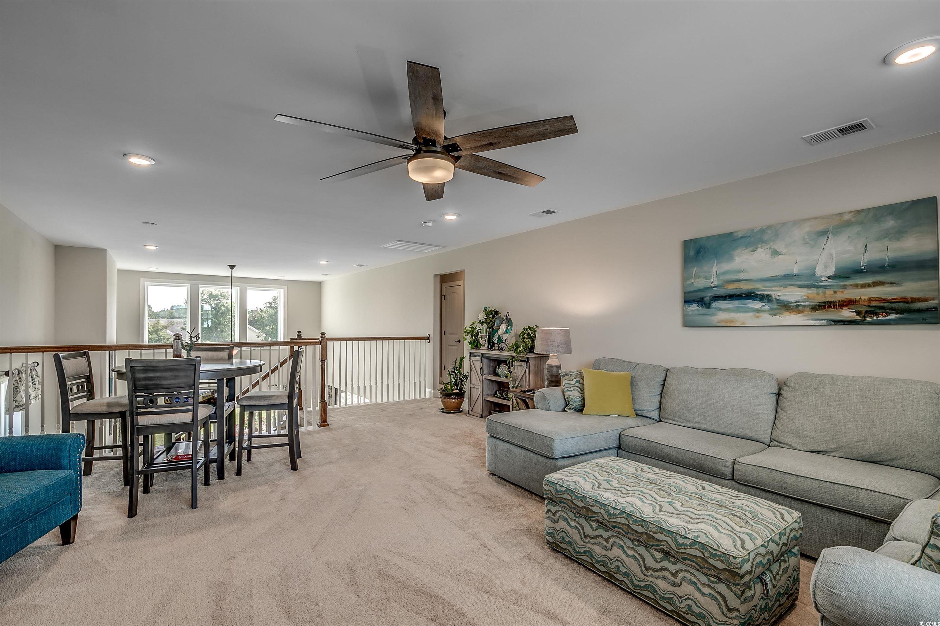 925 Abernathy Place Surfside Beach, SC 29575 - Photo 16 of 40 Living area with light carpet, a ceiling fan, and