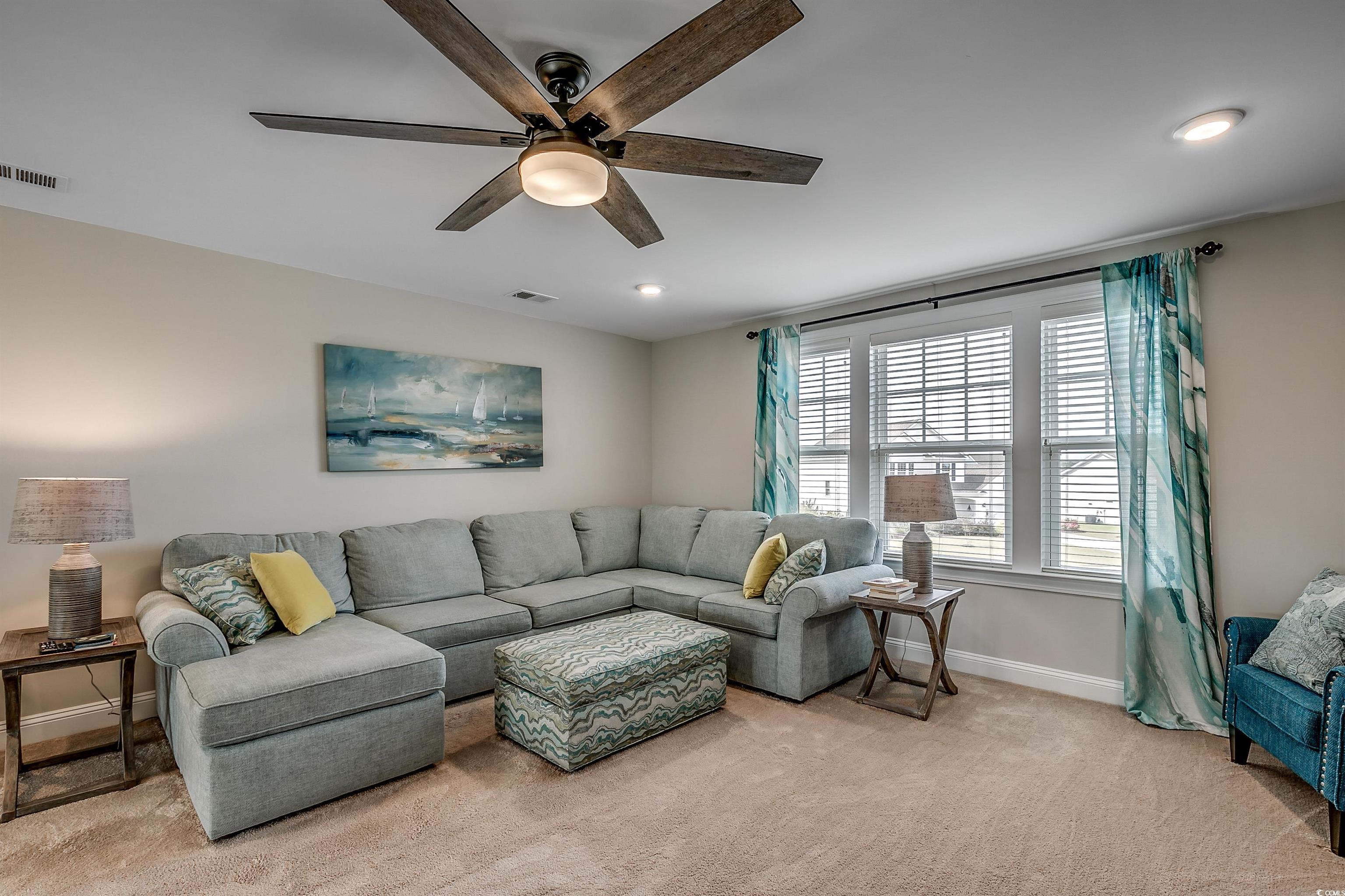 925 Abernathy Place Surfside Beach, SC 29575 - Photo 17 of 40 Living room with baseboards, ceiling fan, light co